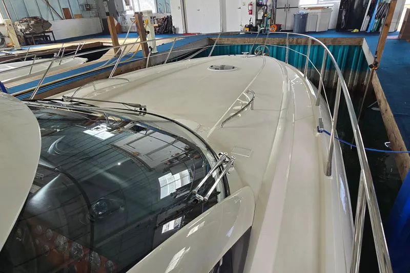 Slide: The Image of 2004 Sunseeker Camargue 50 yacht docked indoors, showcasing sleek design and spacious deck. - 3