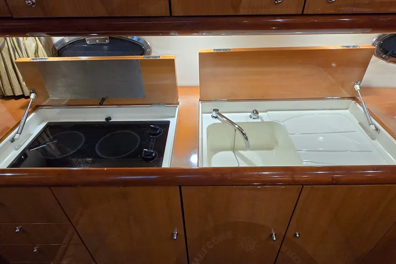 Slide: The Image of 2004 Sunseeker Camargue 50 yacht kitchen with stove and sink. - 32