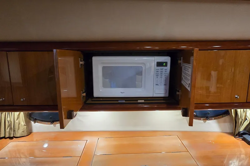 Slide: The Image of Microwave in wooden cabinet aboard 2004 Sunseeker Camargue 50 yacht kitchen. - 33
