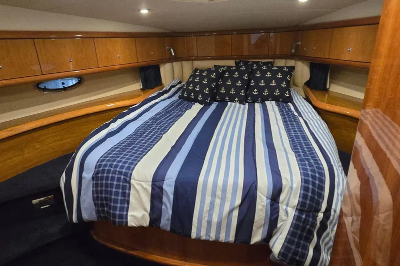 Slide: The Image of Luxurious cabin interior of 2004 Sunseeker Camargue 50 yacht with striped bedding. - 34