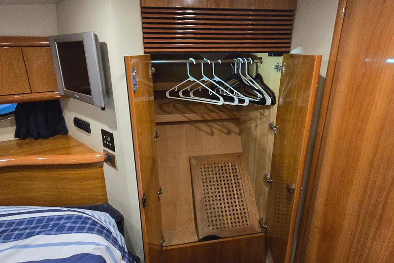 Slide: The Image of Interior of 2004 Sunseeker Camargue 50 yacht with open wooden wardrobe and hangers. - 35