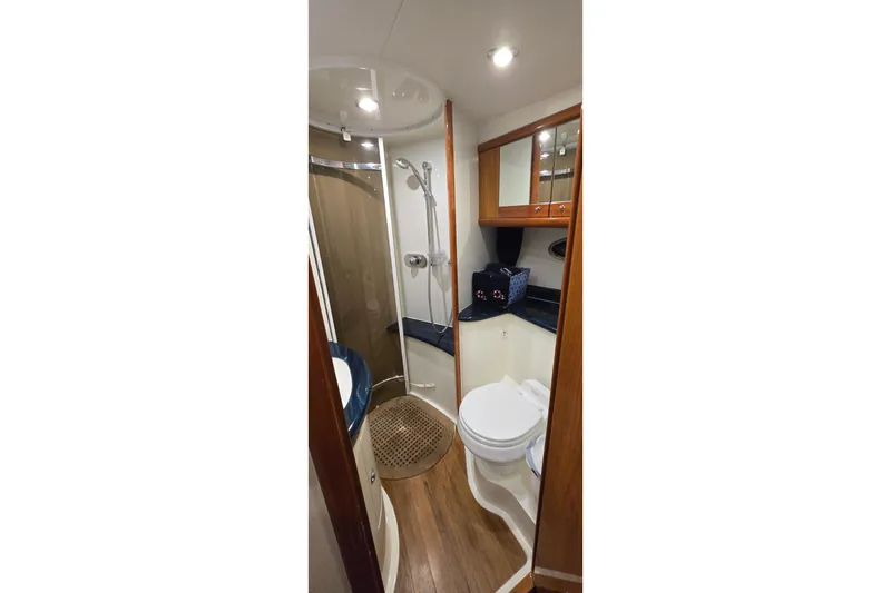 Slide: The Image of Bathroom interior of 2004 Sunseeker Camargue 50 yacht, featuring shower and wooden accents. - 36
