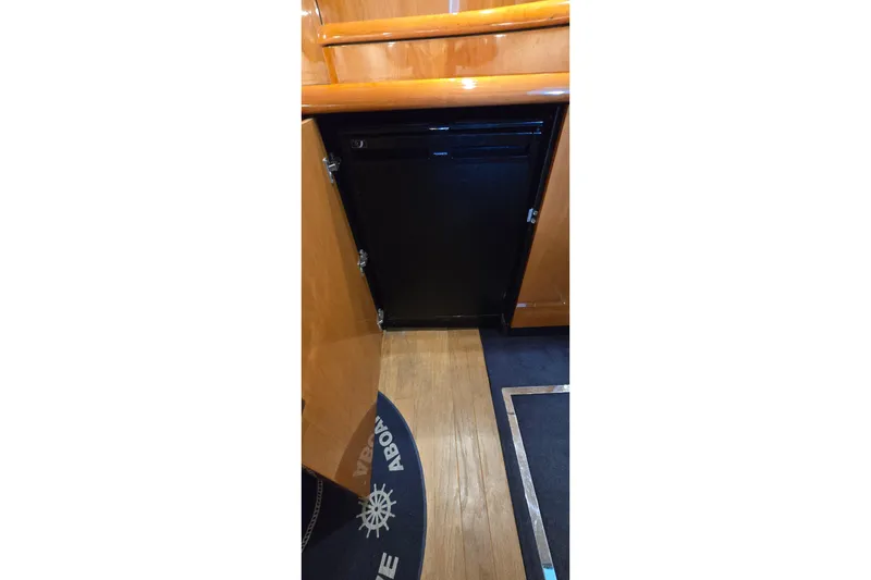 Slide: The Image of Interior of 2004 Sunseeker Camargue 50 yacht, featuring wooden cabinetry and flooring. - 39