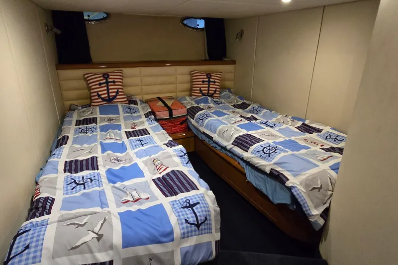 Slide: The Image of Twin cabin with nautical-themed bedding in 2004 Sunseeker Camargue 50 yacht. - 40