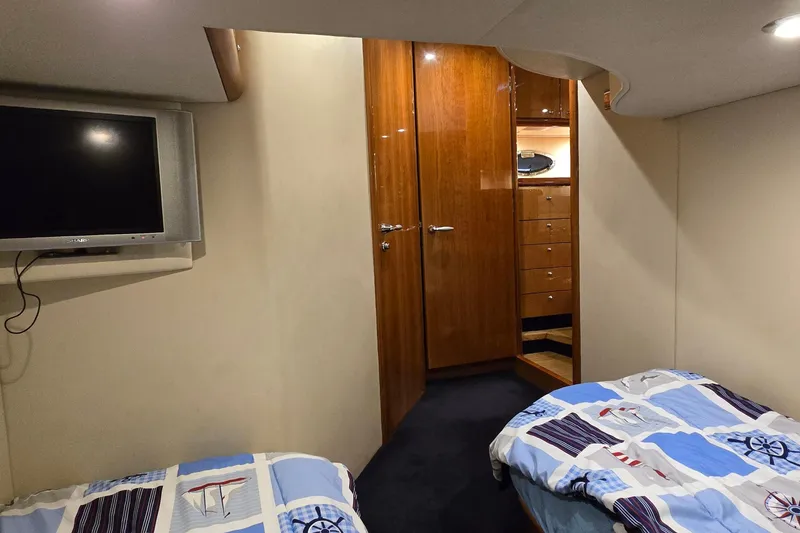 Slide: The Image of Interior cabin of 2004 Sunseeker Camargue 50 yacht with twin beds and TV. - 41