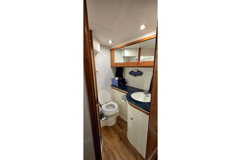 Slide: The Image of Bathroom interior of 2004 Sunseeker Camargue 50 yacht, featuring wood accents and modern fixtures. - 42