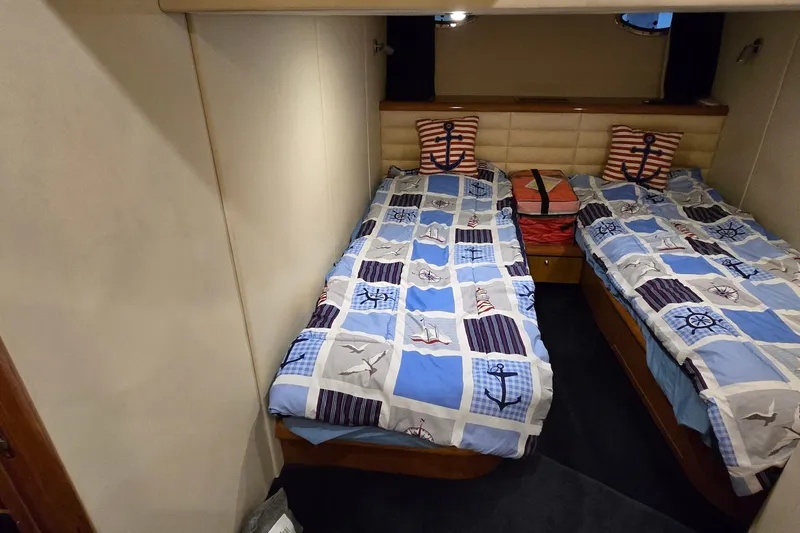 Slide: The Image of Twin cabin with nautical-themed bedding in 2004 Sunseeker Camargue 50 yacht. - 44