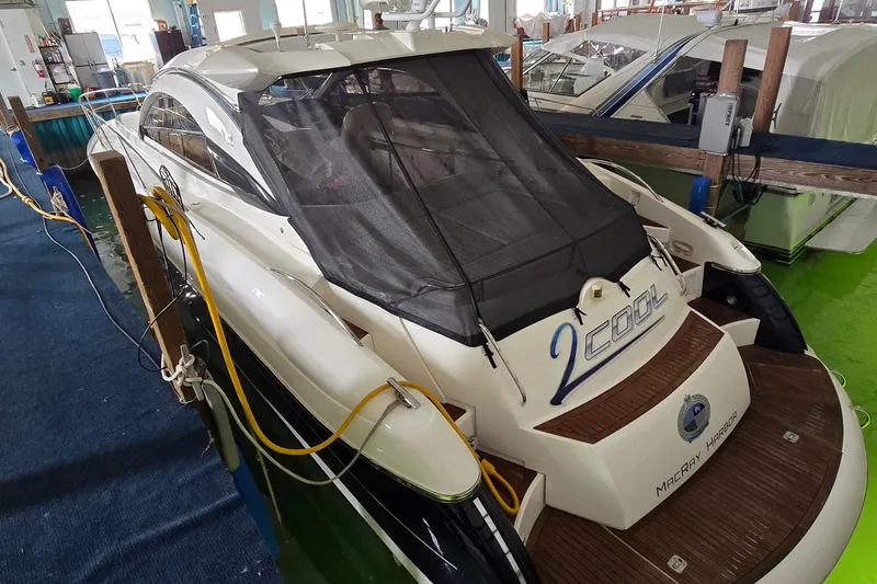 Slide: The Image of 2004 Sunseeker Camargue 50 yacht docked indoors, rear view with protective cover. - 5