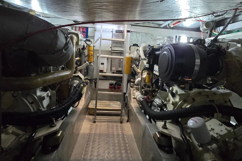 Slide: The Image of Engine room of a 2004 Sunseeker Camargue 50 yacht, showcasing dual engines and mechanical components. - 50