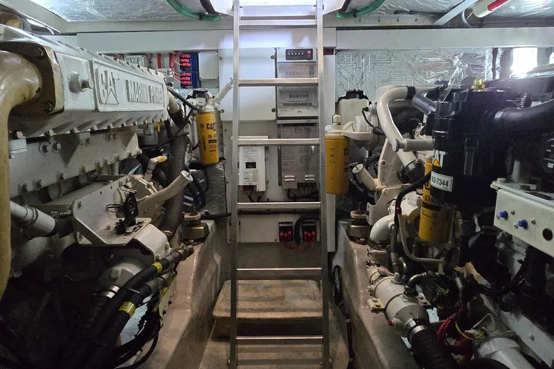Slide: The Image of Engine room of a 2004 Sunseeker Camargue 50 yacht, featuring Caterpillar marine engines. - 51