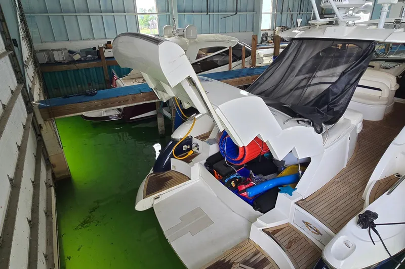 Slide: The Image of 2004 Sunseeker Camargue 50 yacht docked indoors with open storage compartment. - 7