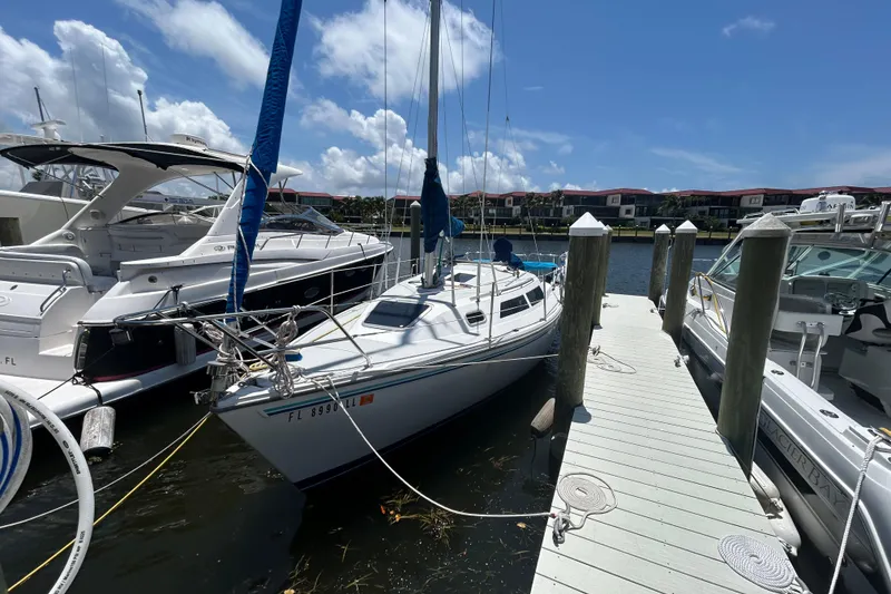 The Image of 1993 Catalina 270 sailboat docked at marina under clear blue sky. - 0