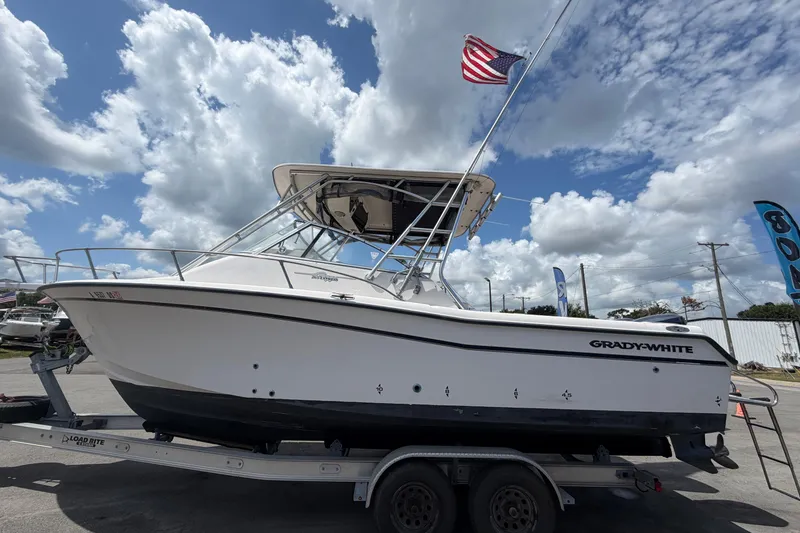 Slide: The Image of 2000 Grady-White Express 265 boat on trailer under cloudy sky. - 10