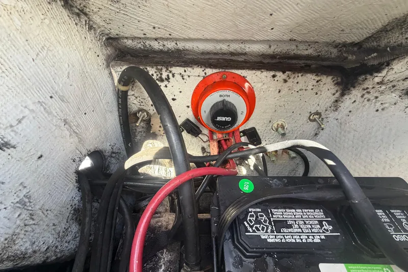 Slide: The Image of Battery compartment of a 2000 Grady-White Express 265 boat with wiring and switch. - 100