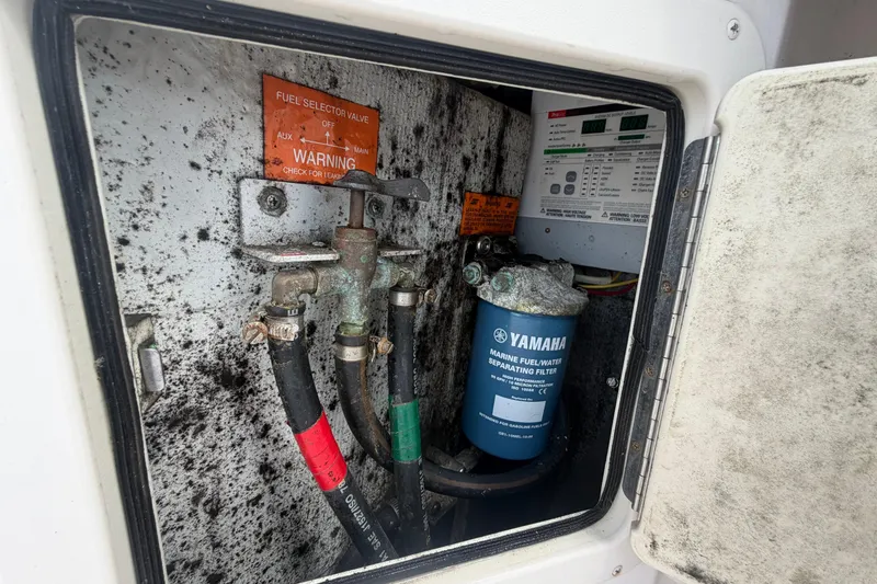 Slide: The Image of Fuel selector valve and Yamaha filter in 2000 Grady-White Express 265 boat compartment. - 102