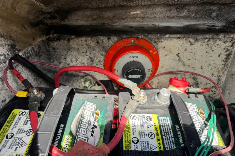 Slide: The Image of Battery compartment of 2000 Grady-White Express 265 with marine batteries and switch. - 108