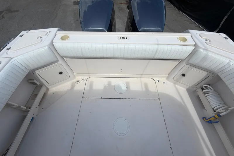 Slide: The Image of 2000 Grady-White Express 265 boat deck with seating and storage compartments. - 109