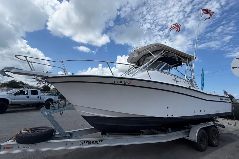 Slide: The Image of 2000 Grady-White Express 265 boat on trailer under cloudy sky. - 11