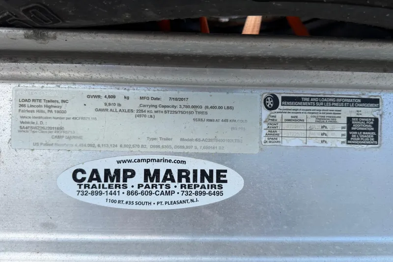 Slide: The Image of Sticker on trailer with Load Rite specifications and Camp Marine contact details. - 114