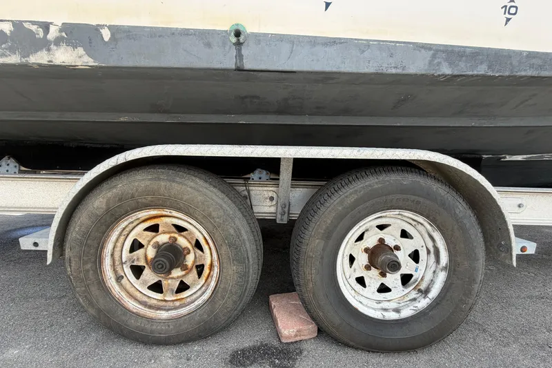 Slide: The Image of Trailer wheels supporting a 2000 Grady-White Express 265 boat. - 116
