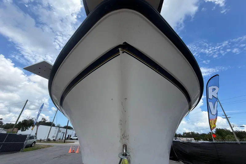Slide: The Image of Front view of a 2000 Grady-White Express 265 boat under a partly cloudy sky. - 13