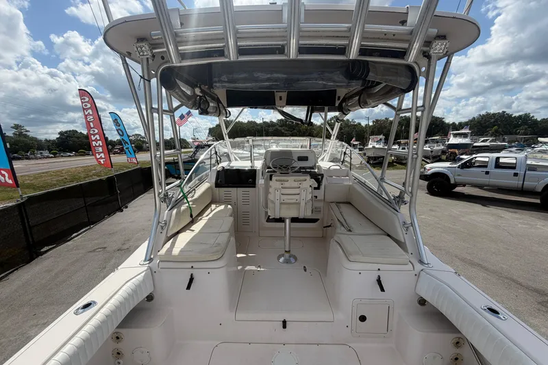 Slide: The Image of 2000 Grady-White Express 265 boat interior with seating and helm, displayed outdoors. - 15