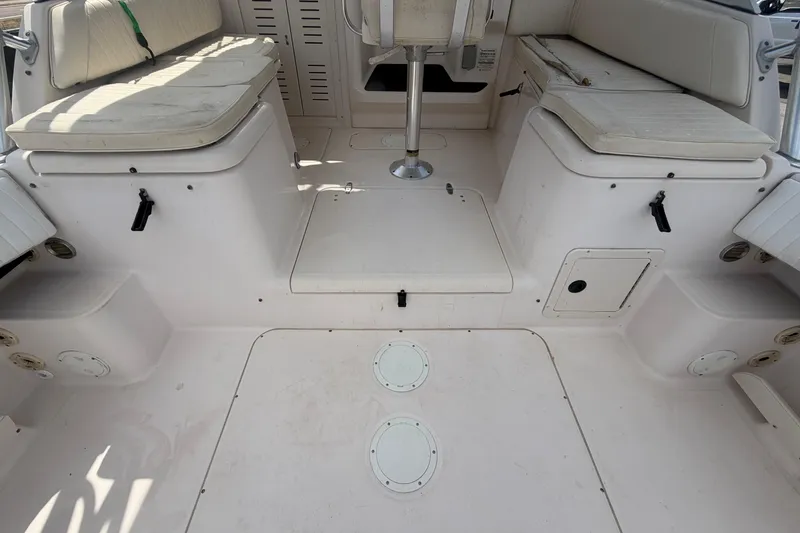 Slide: The Image of 2000 Grady-White Express 265 boat interior with cushioned seating and storage compartments. - 17