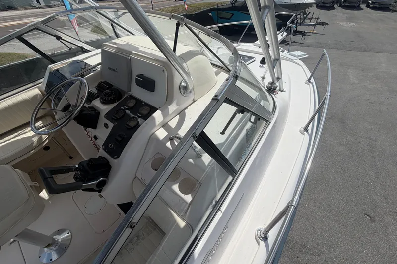 Slide: The Image of 2000 Grady-White Express 265 boat cockpit with steering wheel and control panel. - 19