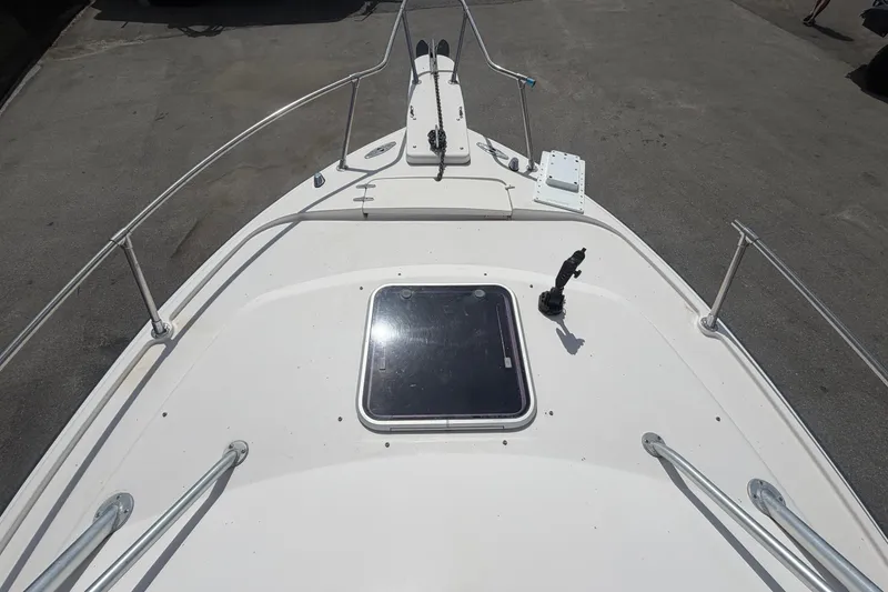 Slide: The Image of Bow view of 2000 Grady-White Express 265 boat, featuring deck hatch and railings. - 20