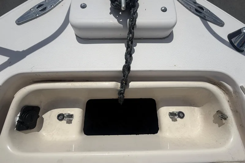 Slide: The Image of Anchor chain compartment on 2000 Grady-White Express 265 boat deck. - 23