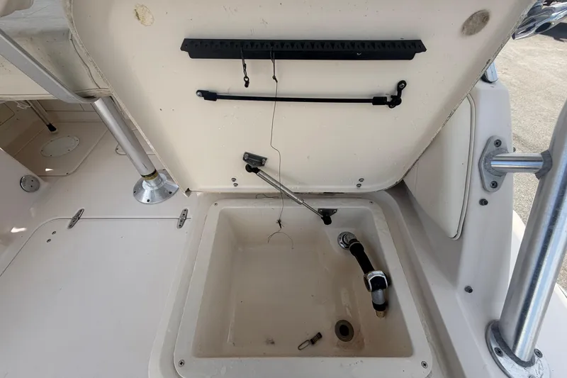 Slide: The Image of Open storage compartment on a 2000 Grady-White Express 265 boat, showing interior details. - 36