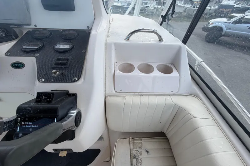 Slide: The Image of 2000 Grady-White Express 265 boat dashboard with Yamaha controls and cup holders. - 40