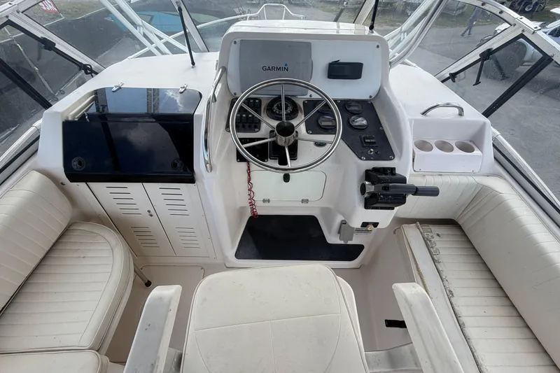 Slide: The Image of Cockpit of 2000 Grady-White Express 265 boat with steering wheel and seating. - 41