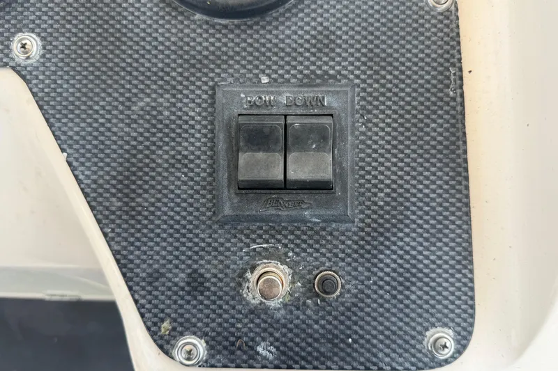Slide: The Image of Control panel on a 2000 Grady-White Express 265 boat with bow down switches. - 48