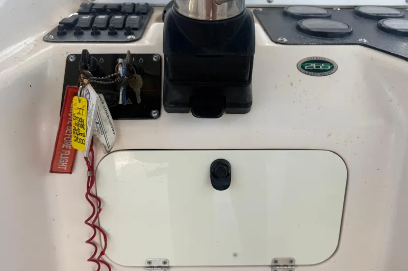 Slide: The Image of Control panel of a 2000 Grady-White Express 265 boat with keys and safety lanyard. - 50