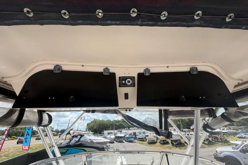 Slide: The Image of 2000 Grady-White Express 265 boat dashboard with overhead storage compartments. - 53