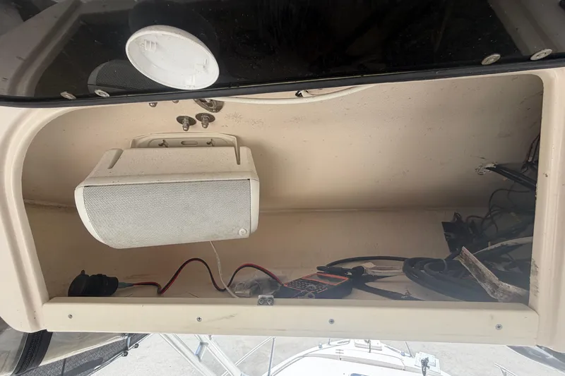 Slide: The Image of Storage compartment on a 2000 Grady-White Express 265 boat with speaker and wiring. - 56