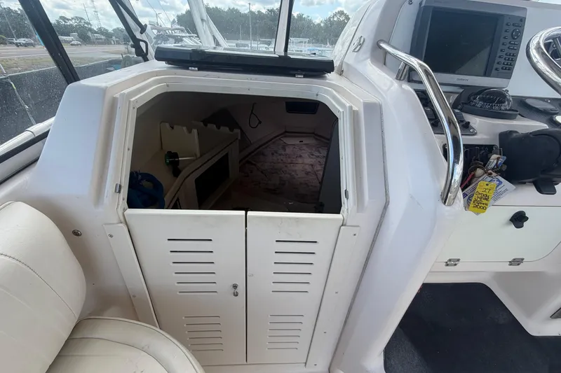 Slide: The Image of Interior view of a 2000 Grady-White Express 265 boat cabin with open hatch. - 58
