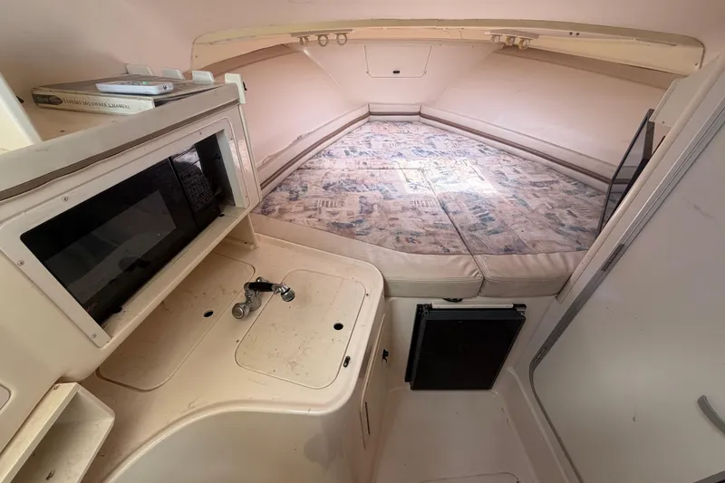 Slide: The Image of Interior of 2000 Grady-White Express 265 boat with kitchenette and sleeping area. - 60