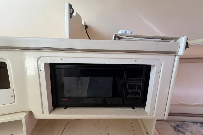 Slide: The Image of Microwave in 2000 Grady-White Express 265 boat interior kitchen area. - 64