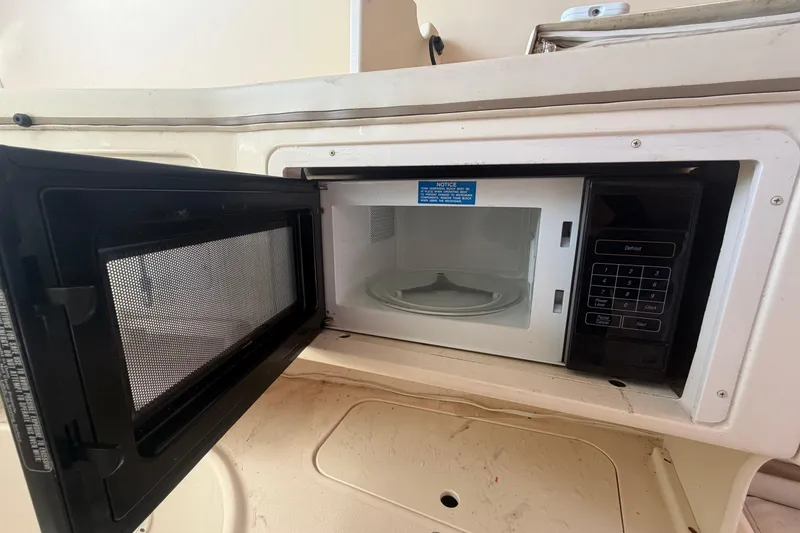 Slide: The Image of Microwave inside 2000 Grady-White Express 265 boat, open door showing interior. - 65