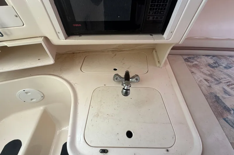 Slide: The Image of 2000 Grady-White Express 265 boat interior with sink and microwave. - 66