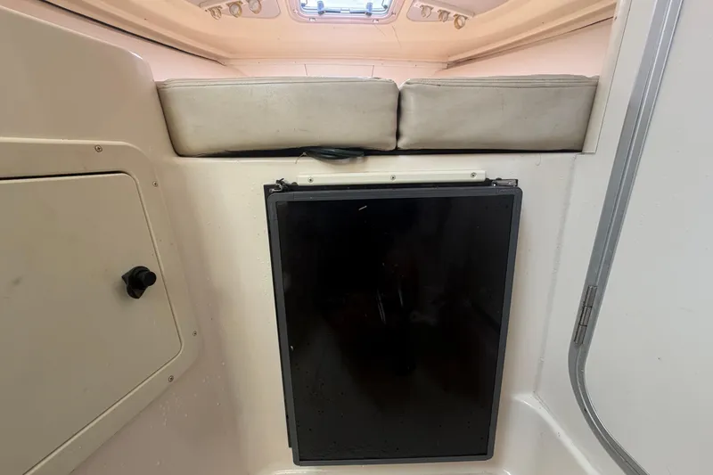 Slide: The Image of Interior cabin of 2000 Grady-White Express 265 boat with seating and storage. - 70