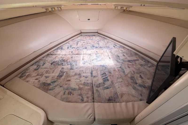 Slide: The Image of Interior cabin of 2000 Grady-White Express 265 boat with patterned bedding. - 72