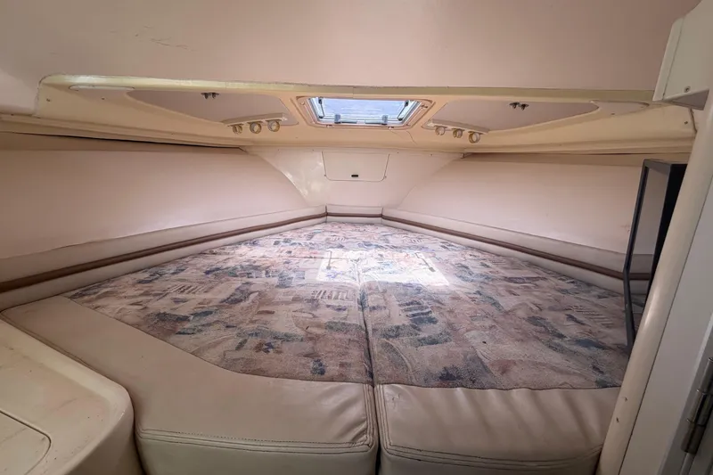 Slide: The Image of Interior cabin of 2000 Grady-White Express 265 boat, featuring a spacious sleeping area. - 73