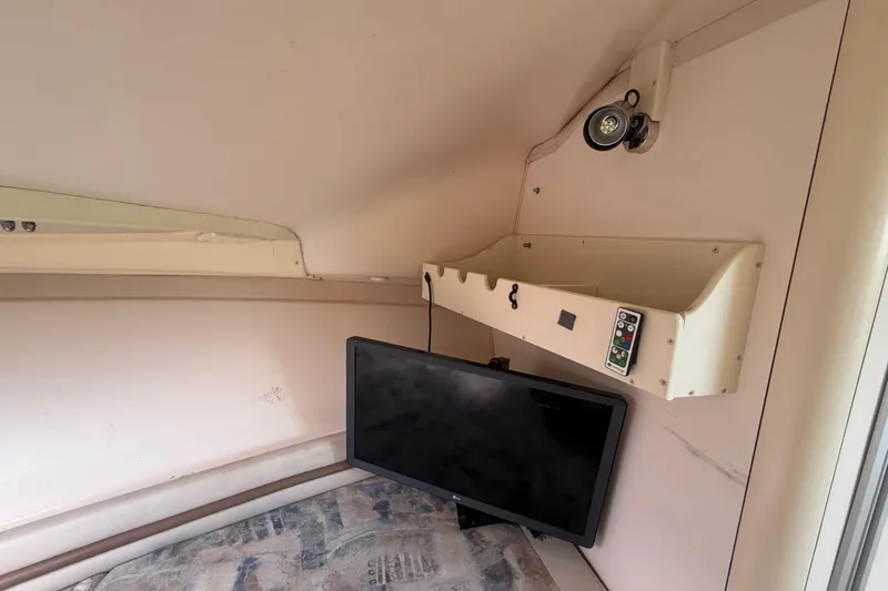 Slide: The Image of Interior cabin of 2000 Grady-White Express 265 with TV and storage shelf. - 75