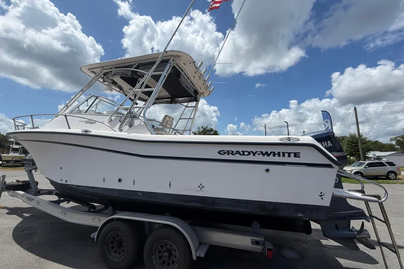 Slide: The Image of 2000 Grady-White Express 265 boat on trailer under cloudy sky. - 9