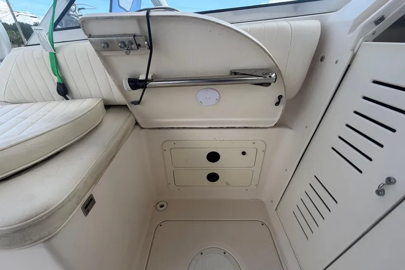 Slide: The Image of Interior view of a 2000 Grady-White Express 265 boat, featuring seating and storage compartments. - 90