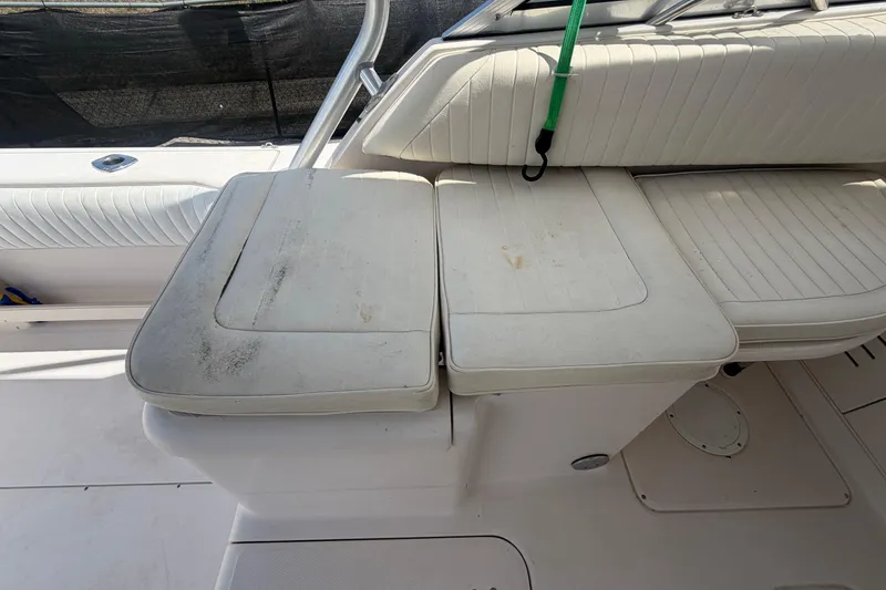 Slide: The Image of White cushioned seating on a 2000 Grady-White Express 265 boat interior. - 92