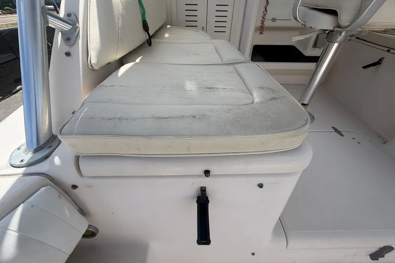 Slide: The Image of Grady-White Express 265 boat interior seating, 2000 model, showing white cushioned seats. - 93